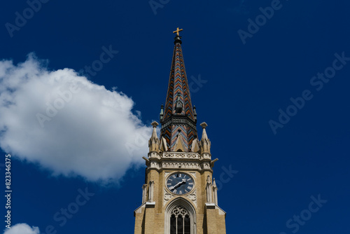 Name of Mary Church, also known as Novi Sad catholic cathedral or crkva imena marijinog during a sunny day. The cathedral is one of the most important landmarks. Tower with clock close view. photo