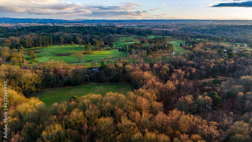 Obraz premium Aerial view of a rural golf course in the late afternoon sunshine