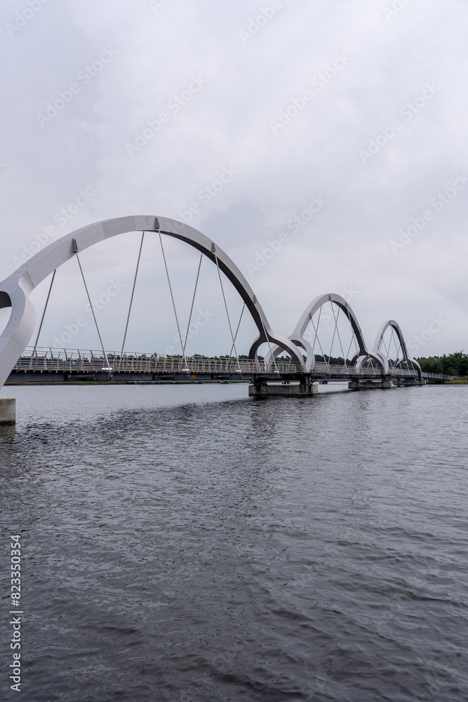 Arched bridge over water under a cloudy sky, Sweden, Soelvesborg Arched bridge over water under a cloudy sky, Sweden, Soelvesborg