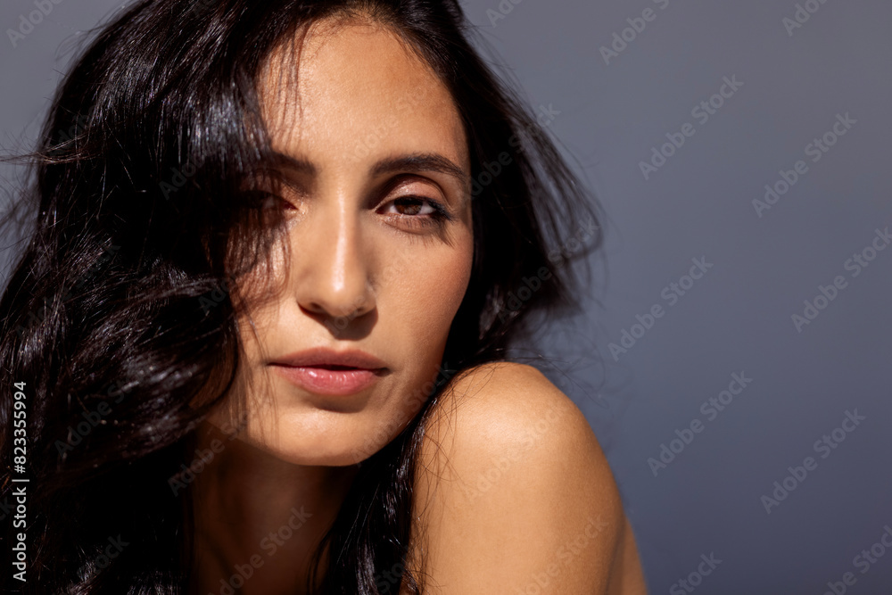 studio portrait of an attractive young woman on a gray background studio portrait of an attractive young woman on a gray background