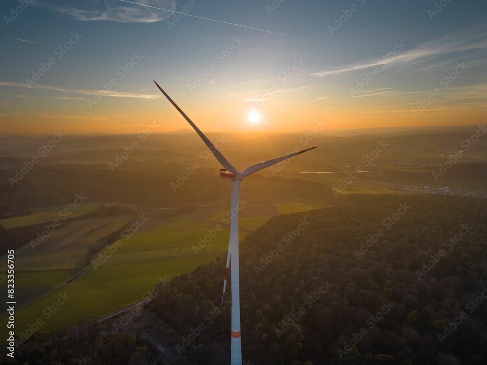 Wind turbine in a wooded area at sunset, near Marburg, Germany Wind turbine in a wooded area at sunset, near Marburg, Germany