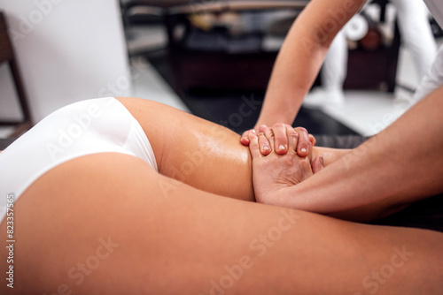 Masseuse makes anti cellulite massage of buttocks  thighs and legs to her client