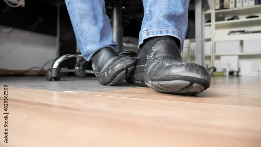 Slow-motion on male feet with black socks taking off shoes on parquet floor Slow-motion on male feet with black socks taking off shoes on parquet floor