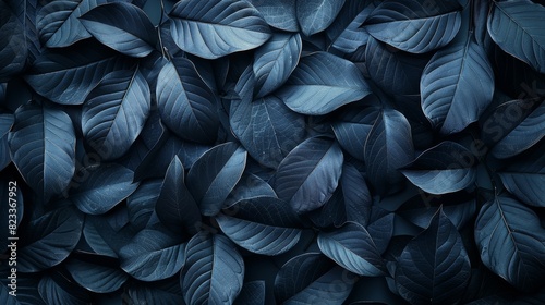 An intricate pattern of dark blue leaves filling the entire image frame