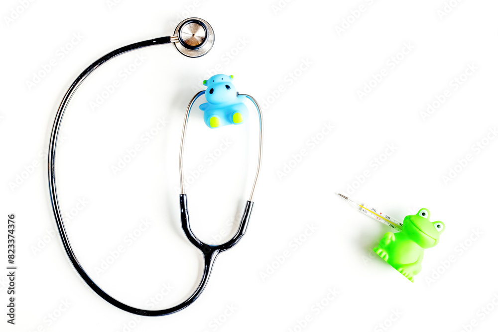 Pediatrics equipment with toys, stethoscope white background top view space for text Pediatrics equipment with toys, stethoscope white background top view space for text