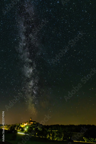 Vertical shot of a beautiful milky way sky over Abbey Andechs, Bavaria, Germany © Wirestock