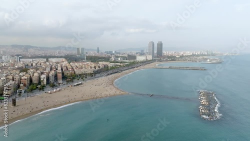Aerial drone panorama of Villa Olimpica del Poblenou, in the city of Barcelona. Twin skyscrapers of Hotel Arts and Torre Mapfre next to Port Olimpic. photo