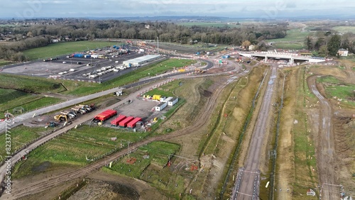 an aerial view of a train station and green grass on the tracks