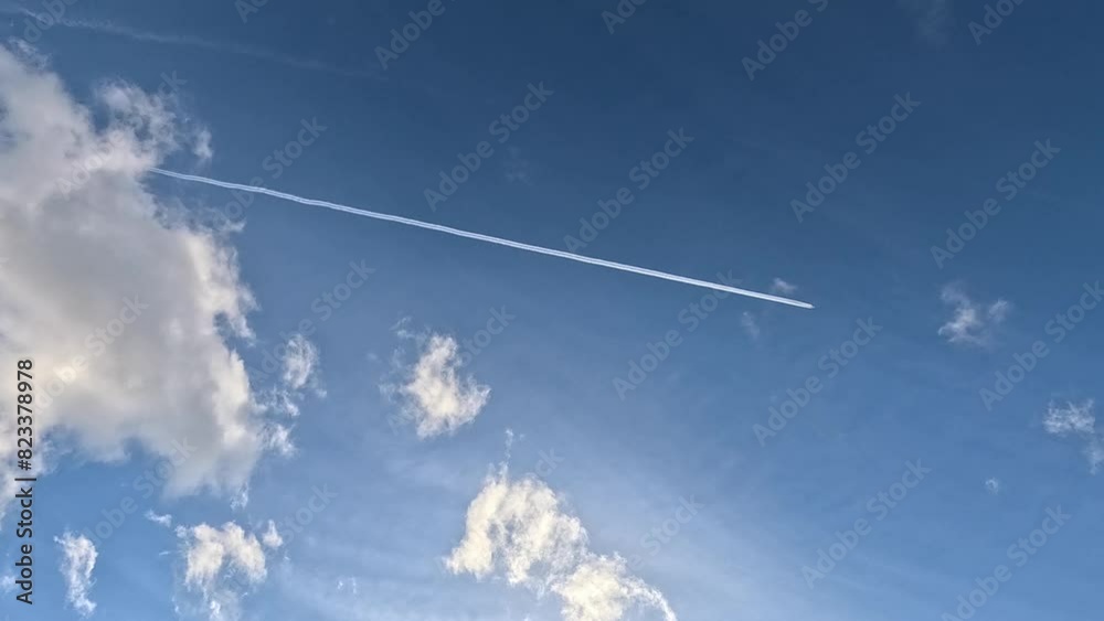 Timelapse of white clouds and chemtrails in the blue sky on a sunny day Timelapse of white clouds and chemtrails in the blue sky on a sunny day