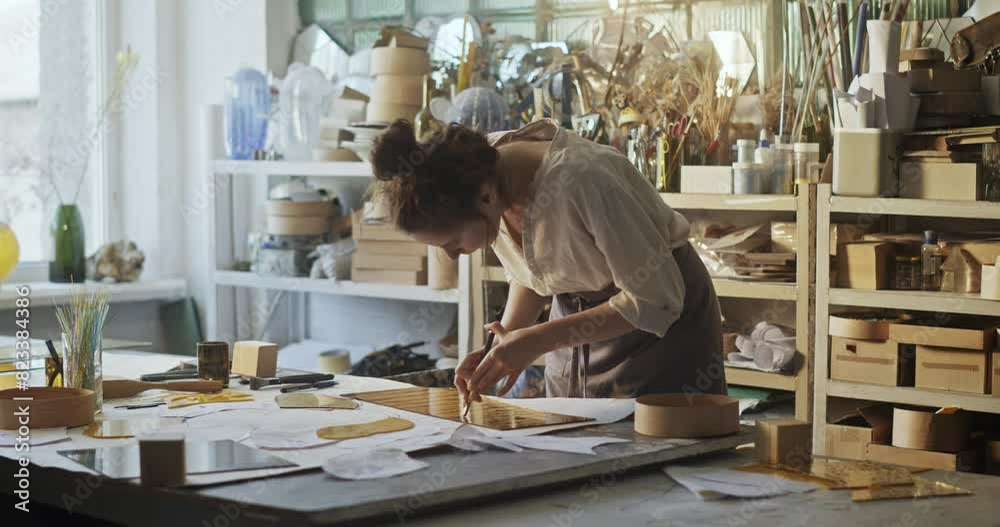 Glass Artist Assembling a Large Floral Mirror in Creative Workshop