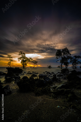 Vertical shot of the scenic coast of Anyer town at sunset in Banten, formerly West Java, Indonesia photo