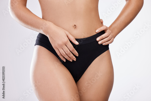 Underwear, hands and woman on diet for stomach, abdomen or lose weight isolated on white studio background. Panties, skin and model touch slim waist to check body for skincare health and wellness © peopleimages.com