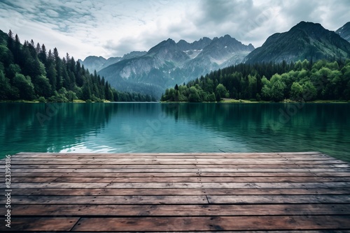 a wooden deck over a lake with mountains in the background