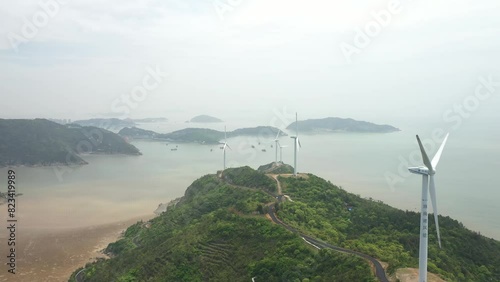Drone shot of the Guangdong Taishan Chuandao Shangchuandao Island Wind Farm on a foggy day, China photo
