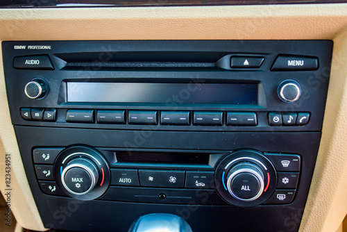 Close-up radio tape recorder in a car with many buttons and switches	
