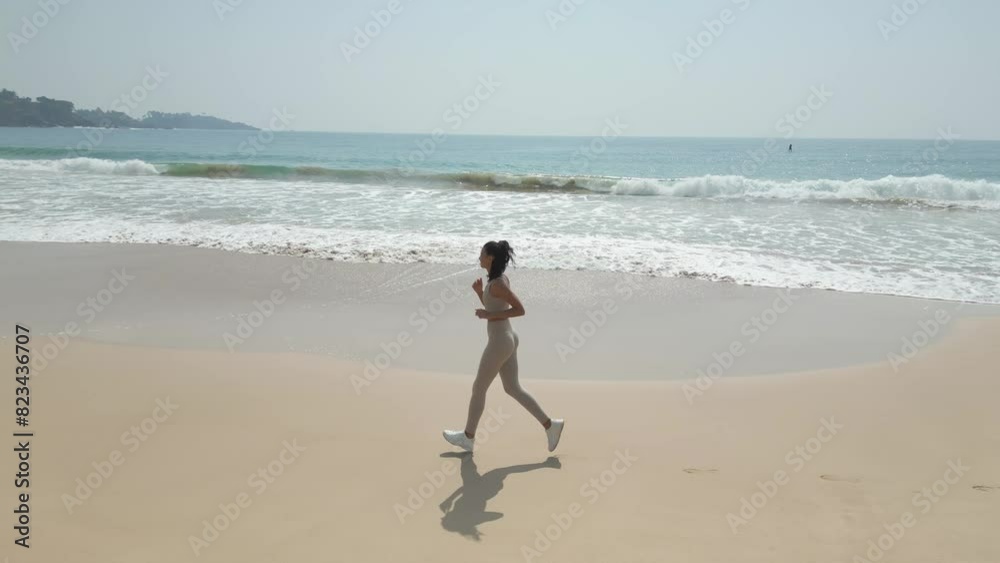 Aerial Tracking Drone Shot of Runner Jogger Woman During Run on Beach Aerial Tracking Drone Shot of Runner Jogger Woman During Run on Beach