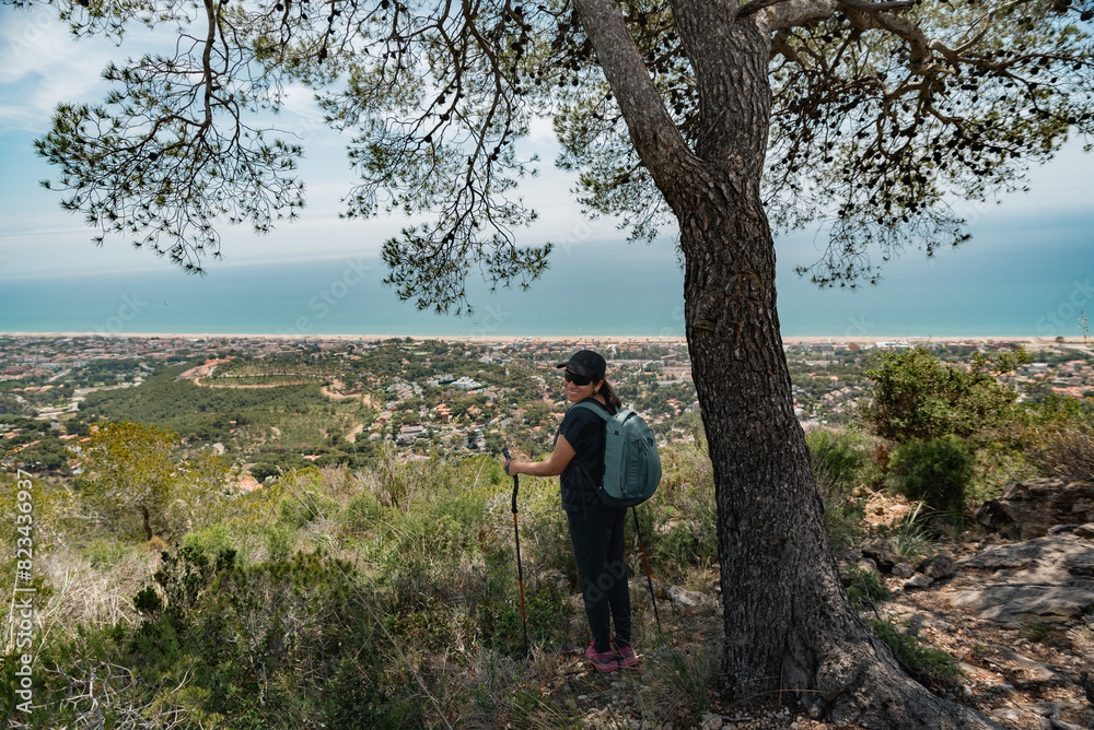 Happy hiker in the mountains and the Mediterranean coast in the background. Happy hiker in the mountains and the Mediterranean coast in the background.