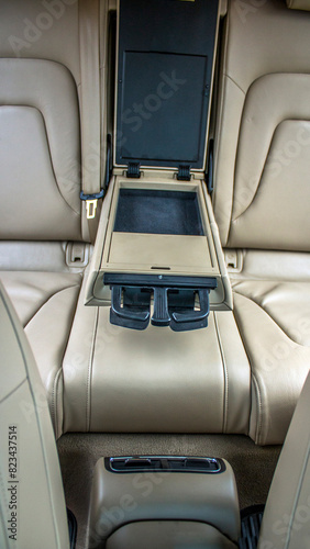 Folding armrest with cup holders for beige leather car interior © Vladimir Bartel