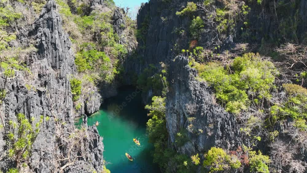 Aerail view of tourist kayakers at tropical bay and clear water of El Nido Palawan, Philippines. Aerail view of tourist kayakers at tropical bay and clear water of El Nido Palawan, Philippines.