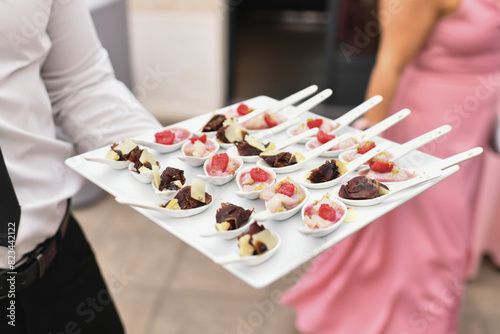 A waiter serving small appetizers at a wedding