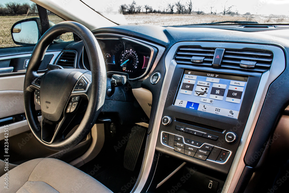 Black steering wheel and dashboard inside a car Black steering wheel and dashboard inside a car
