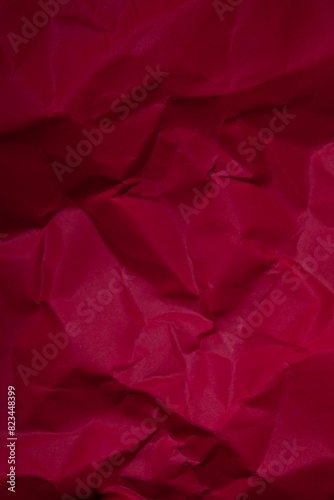 Piece of red wrinkled paper texture background  photo
