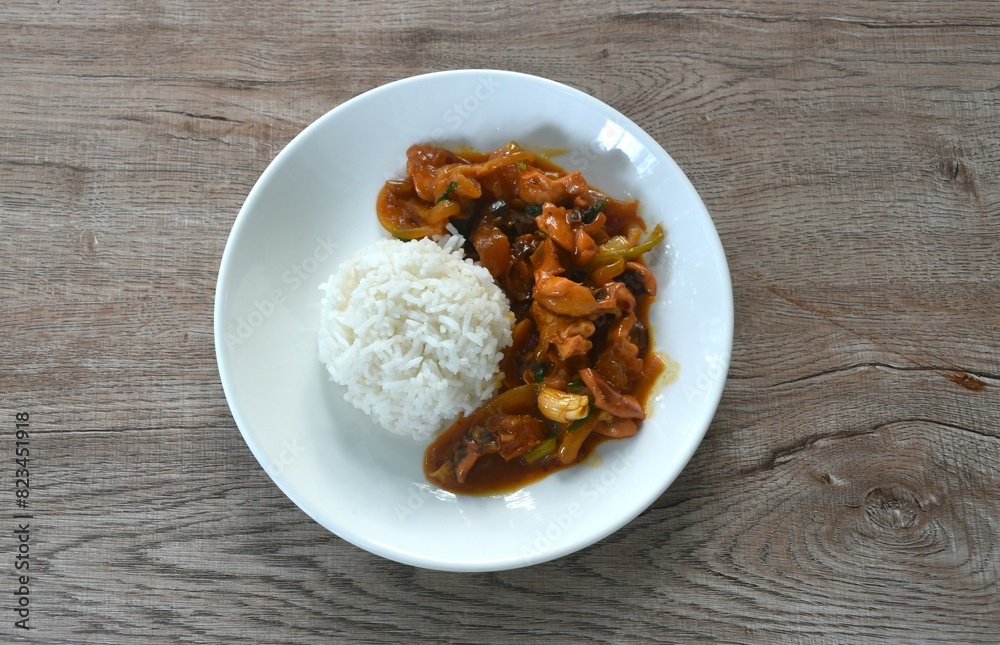 stir-fried squid with salt egg topping plain rice on dish stir-fried squid with salt egg topping plain rice on dish