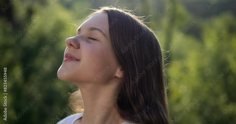 The girl breathes fresh air in nature. Positive mood from good weather and clean environment. The girl breathes fresh air in nature. Positive mood from good weather and clean environment.