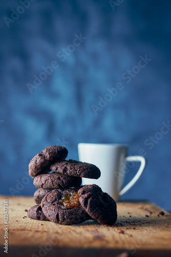 Pile of carob seeds with white cup on blue background photo