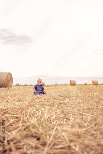 baby girl on field of wheat