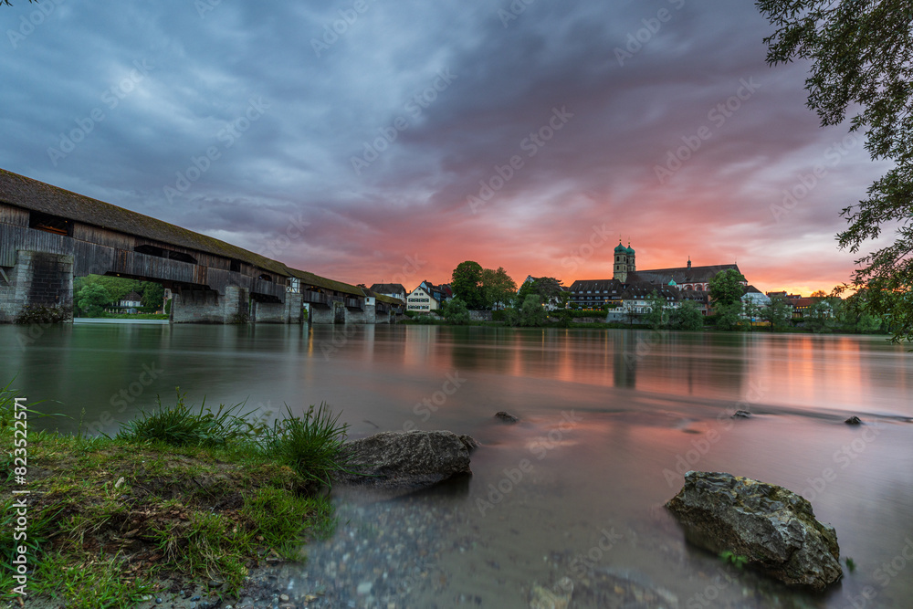 Naklejka premium sunset over the skyline of bad säckingen germany at the river rhine with the historic wooden bridge