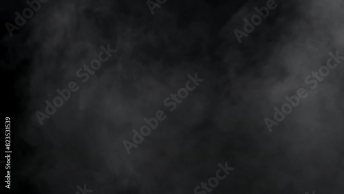 Thick, white smoke gracefully expands and fills the frame against a stark black backdrop. Perfect for overlays, transitions, or visual effects needing a smooth, ethereal quality. photo
