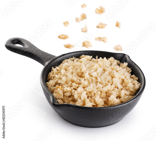 Panko bread crumbs in a sauce pan isolated on white background. Flying bread crumbs. With clipping path.