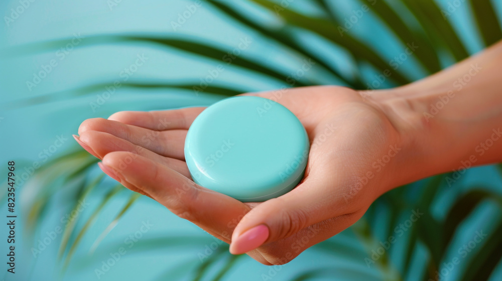 Vibrant turquoise cream mockup in a woman's hand, round and refreshing. Vibrant turquoise cream mockup in a woman's hand, round and refreshing.
