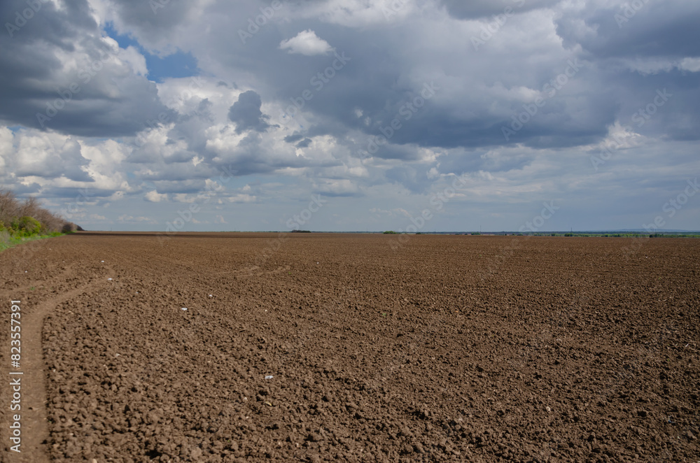 A ploughed field for planting, a dark sky with light gaps. minimalism A ploughed field for planting, a dark sky with light gaps. minimalism