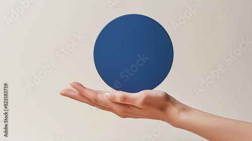 Bold royal blue cream mockup in a feminine hand, perfectly circular. photo