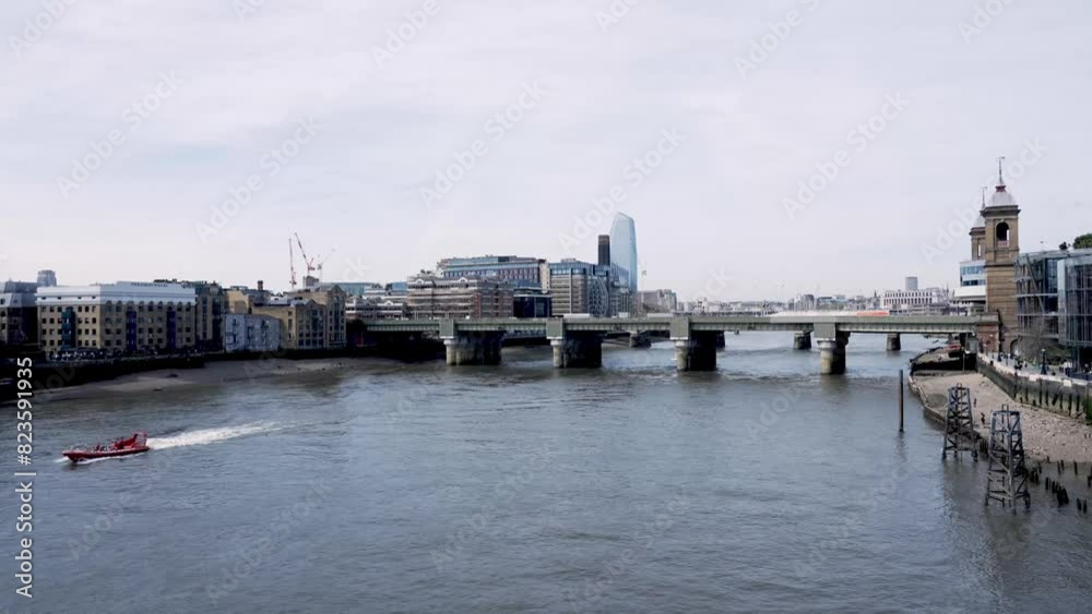 Thames seen from above. London on a sunny day. Ferries and boats ply the river. Tall skyscrapers in the distance. Tourism, business, modern cities. 4k slow motion video. Thames seen from above. London on a sunny day. Ferries and boats ply the river. Tall skyscrapers in the distance. Tourism, business, modern cities. 4k slow motion video.