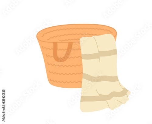 A beach bag made of straw with a towel.