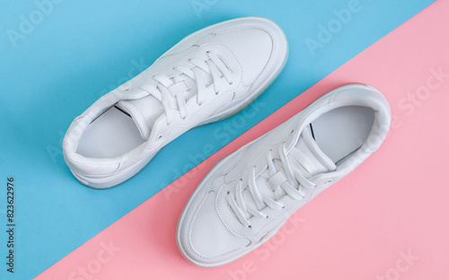 White sneakers on a blue-pink background.