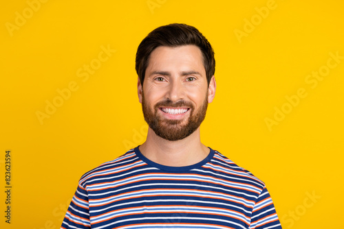 Wallpaper Mural Portrait of positive cheerful guy with stylish stubble wear striped t-shirt toothy smiling at camera isolated on yellow color background Torontodigital.ca