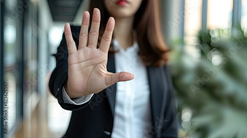 Stop, hand sign and woman with no gesture for sexual harassment and violence in workplace. Business professional © Sattawat