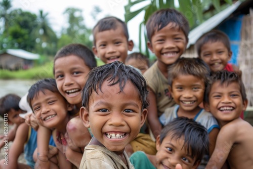 Group of asian kids smiling and looking at the camera in a village