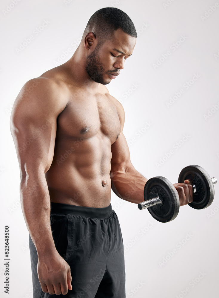 Workout, man and dumbbell in studio with muscles, bodybuilder and exercise for health and wellness training. Bicep, fitness and weightlifting for strength or body goal, power and serious athlete Workout, man and dumbbell in studio with muscles, bodybuilder and exercise for health and wellness training. Bicep, fitness and weightlifting for strength or body goal, power and serious athlete