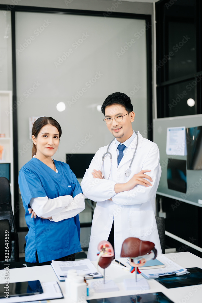 Fototapeta premium Successful team of medical doctors looking at camera and smiling while standin. Health, professional and people team in hospital