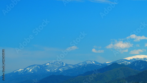 Clouds Run Over The Mountains On A Sunny Day. Winter Forest High In The Mountains. Real time. photo