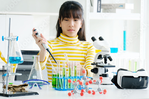 Girl doing science experiment science classroom.