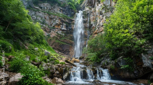 Vertical photo of a waterfall cascading down a rocky cliff  with lush greenery on either side --ar 16 9 --style raw Job ID  d348d0e6-da21-4b72-a58d-030aeb583cd2