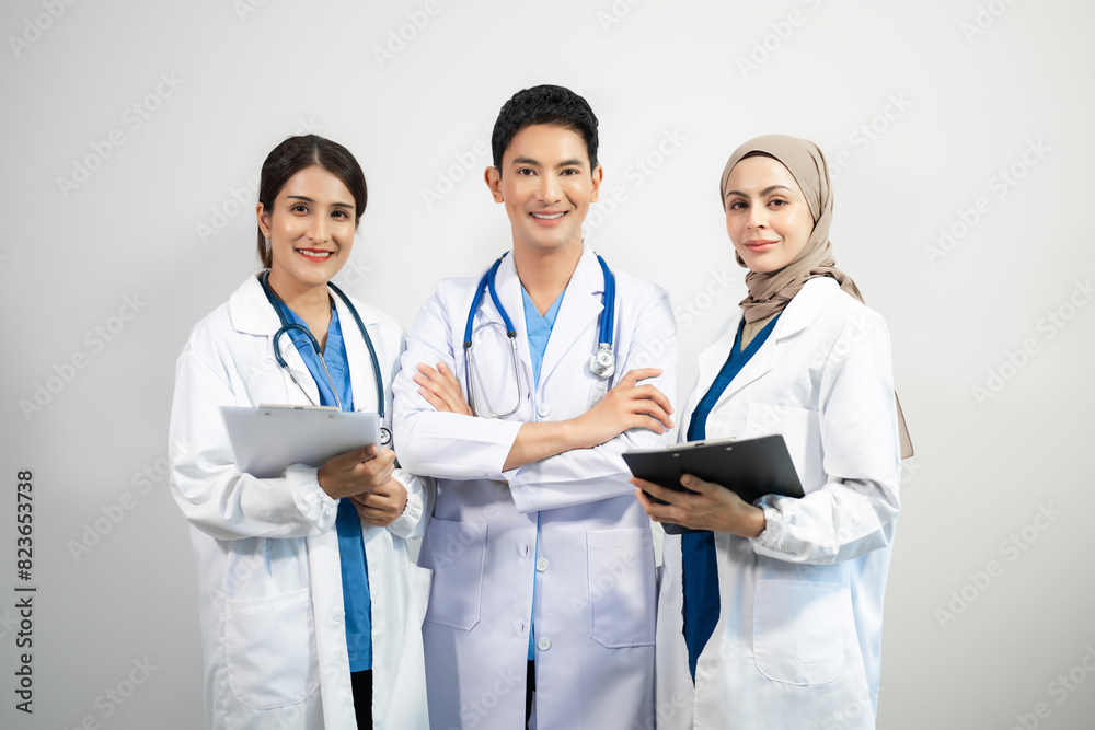 Successful team of medical doctors looking at camera and smiling while standin. Health, professional and people team in white background