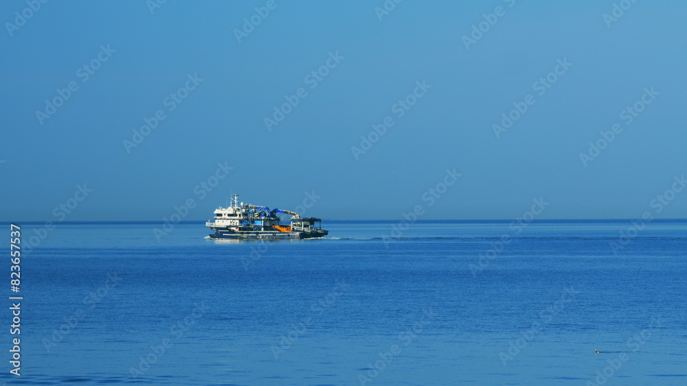 Obraz premium Fishing Vessel Sailing On Waves In Sea To Fish. Sea Summer Ocean Daylight Nature Background. Still.