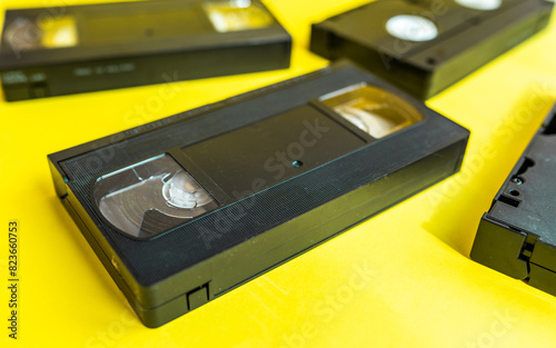 Video cassette tape on a yellow background. Retro videotape with movie.